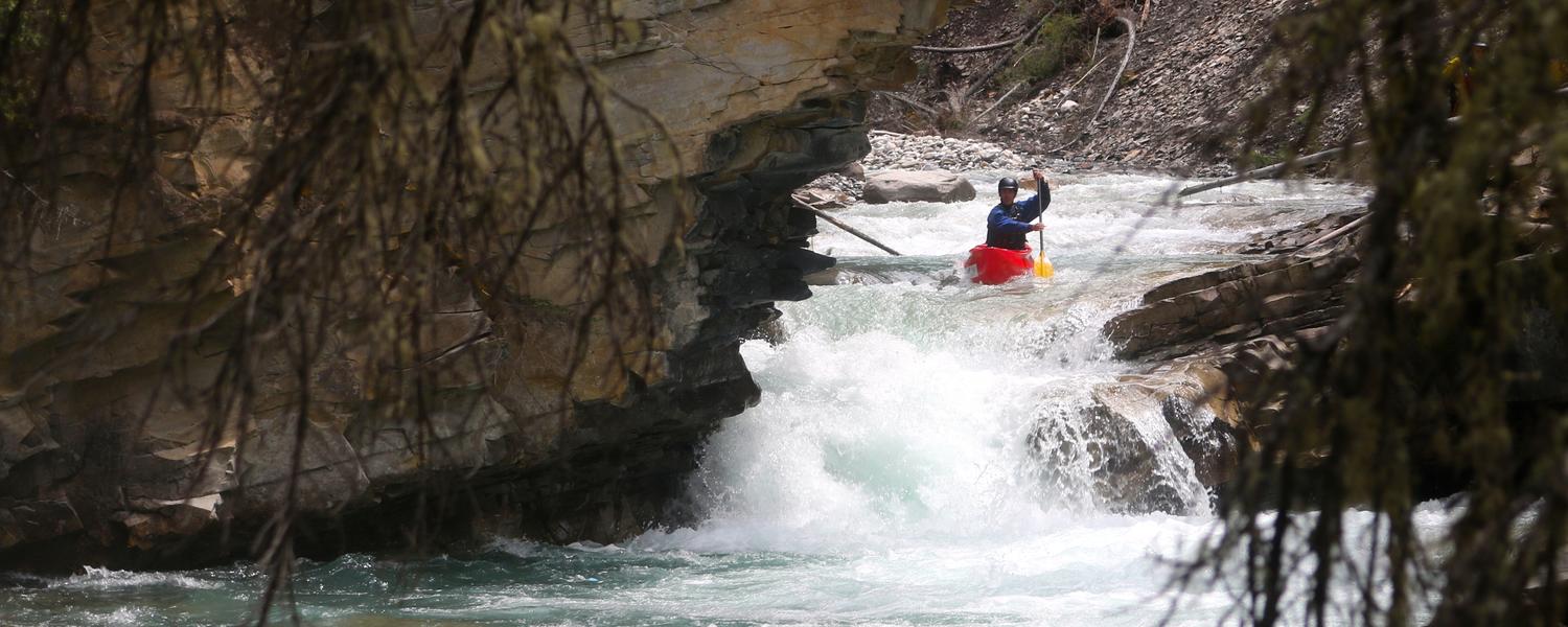 Fin solo canoeing in Johnston Canyon whitewater