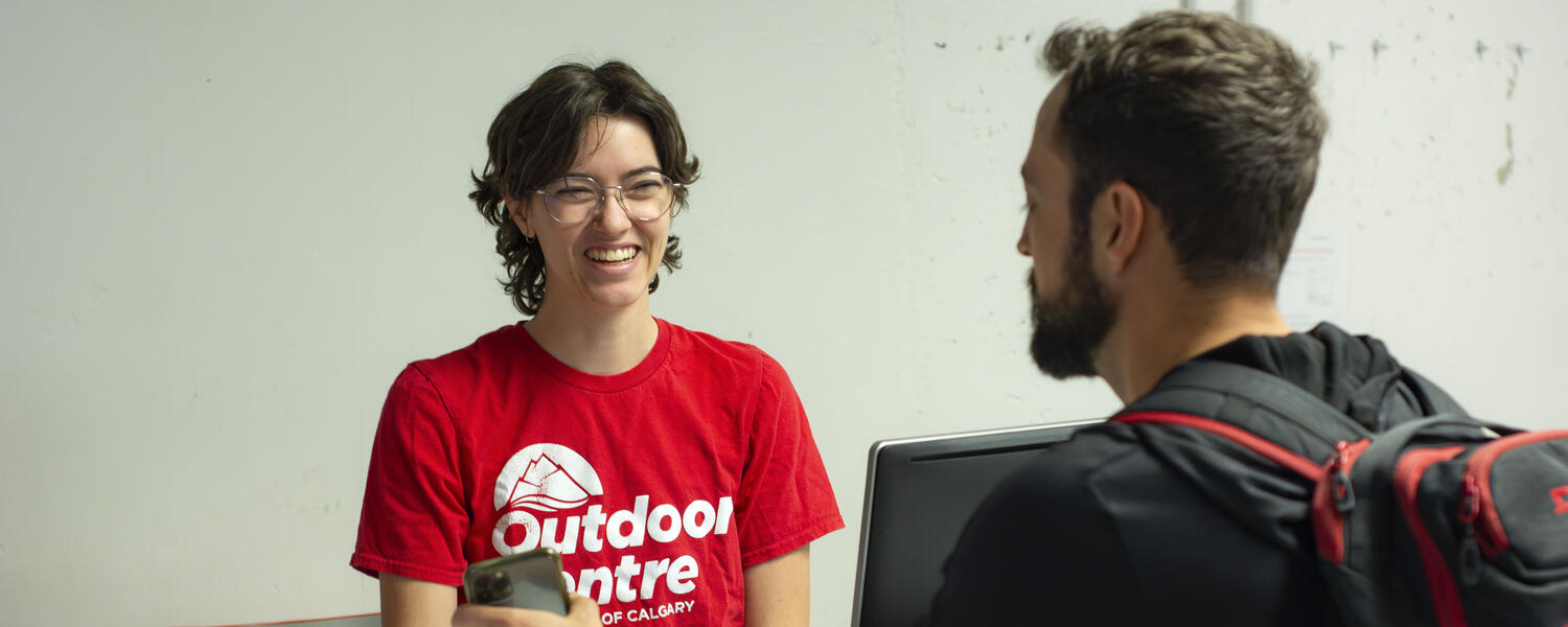 client talks to staff member in Outdoor Centre shirt