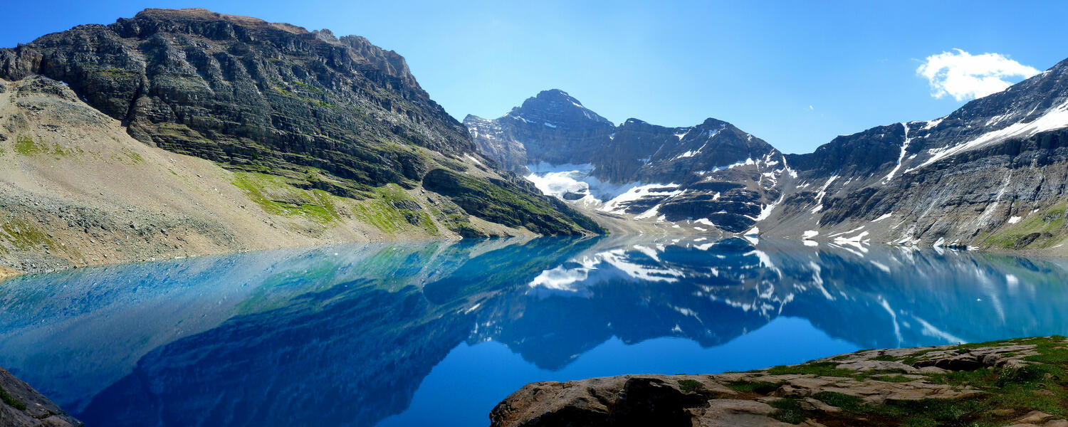 mountain peaks behind large alpine lake