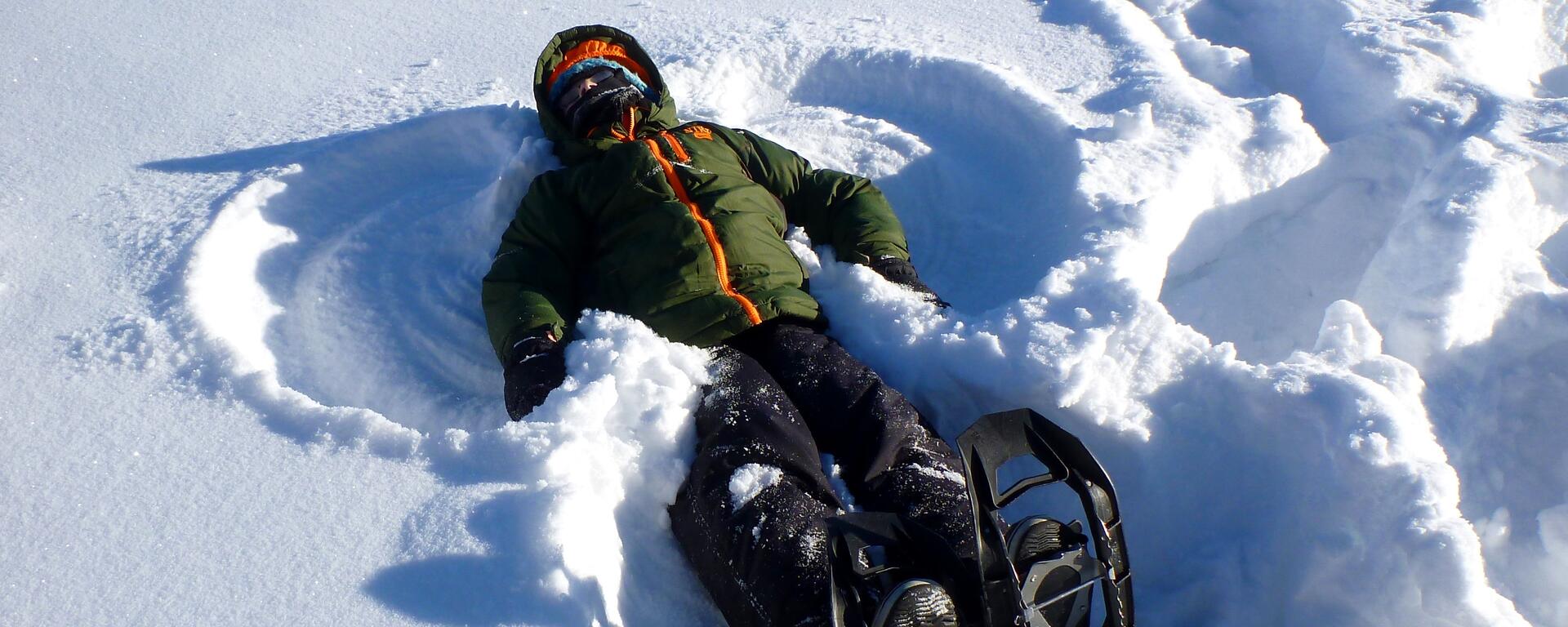child making snow angel