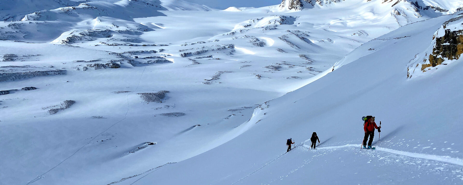 skiers ascend slope