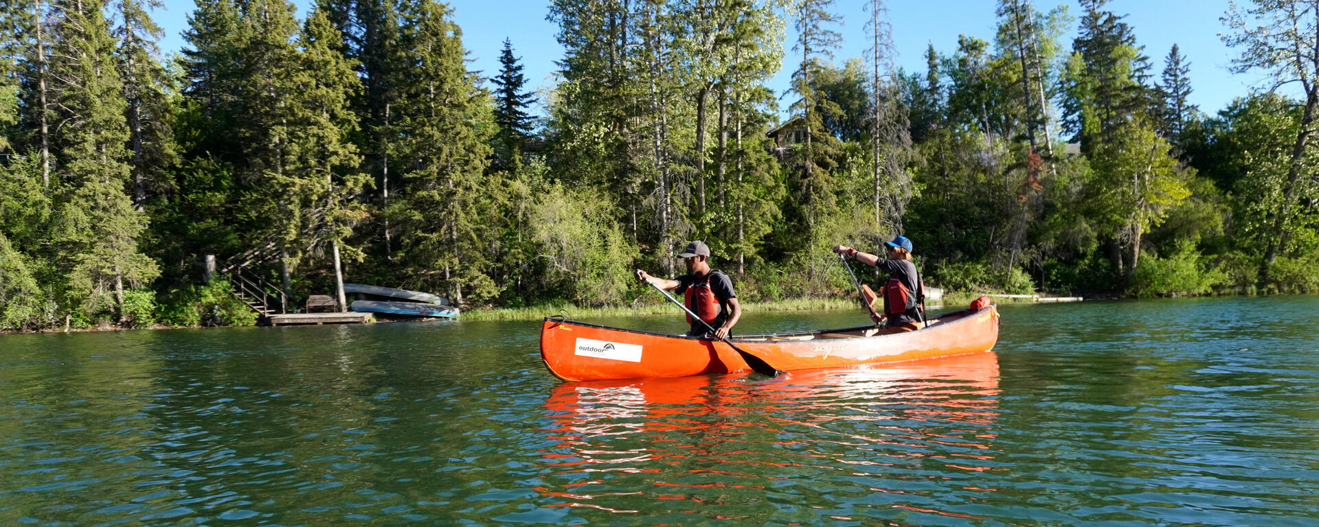 two men in canoe on flatwater