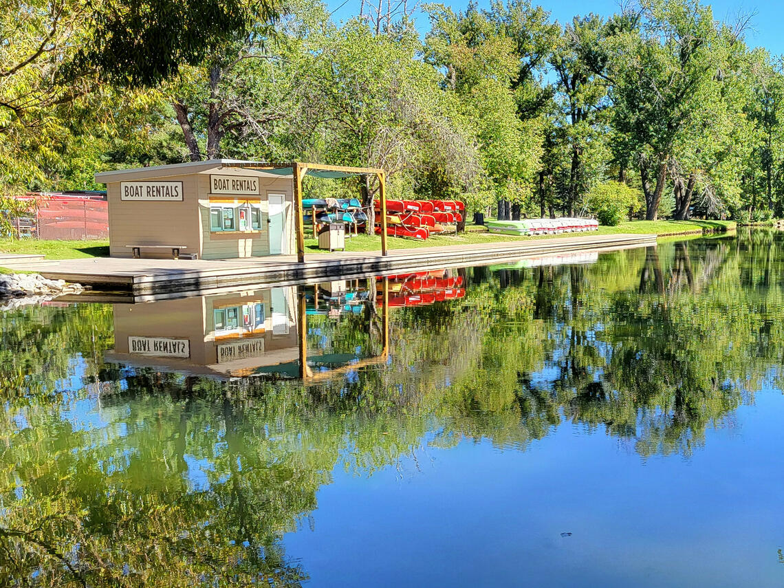 Bowness boathouse and dock reflected in calm water