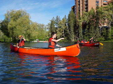 canoe on city lagoon