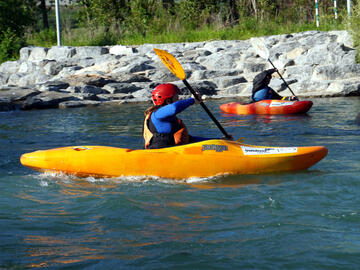 whitewater kayakers turning on river