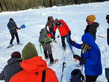 instructor explaining avalanche gear