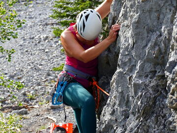 climber looks at foot placement