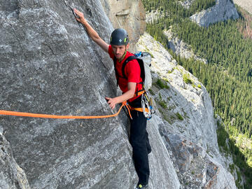 Climber traverses on ledge