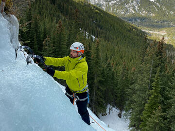 climber on smooth ice with mountain behind