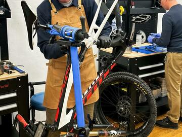 man working on bike at stand