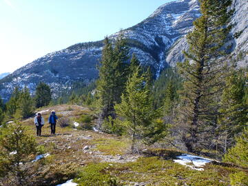 two hikers walk along open ridgetop