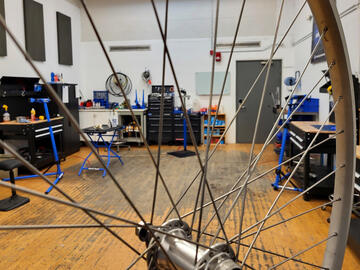 bike shop as viewed through wheel spokes