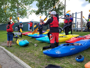 kayakers practicing strokes on land