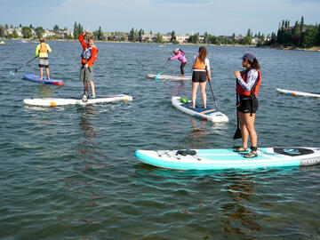 SUP paddlers on lake
