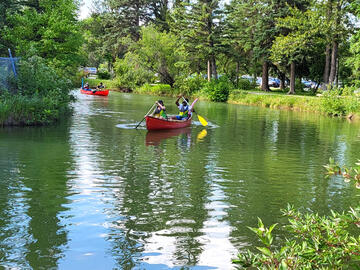 Canoes in calm canal water