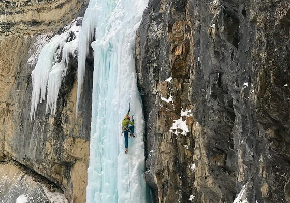 ice climber on frozen fall