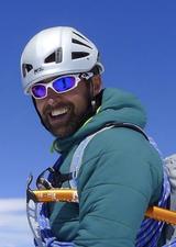 Paul in climbing helmet with sunglasses and ice axe