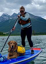 Lauren on paddleboard with dog