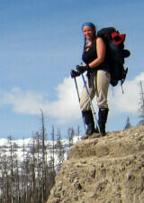 Rachel with backpack on rock