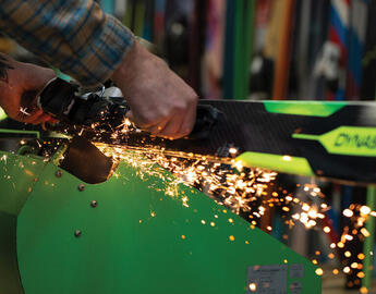 sparks fly from ski grinder